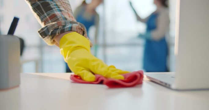 Close up of professional janitor cleaning table in office