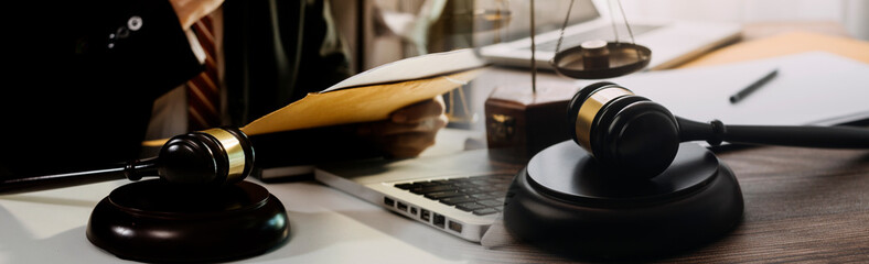 Business and lawyers discussing contract papers with brass scale on desk in office. Law, legal services, advice, justice and law concept picture with film grain effect