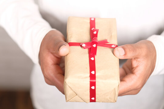 close up of man's hand holding a gift box with copy space 