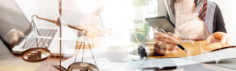 Business and lawyers discussing contract papers with brass scale on desk in office. Law, legal services, advice, justice and law concept picture with film grain effect