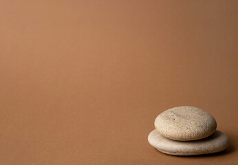 Fototapeta na wymiar Stone cairn on striped brown background, five stones tower, simple poise stones, simplicity harmony and balance, rock zen sculptures