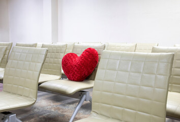 A velvet red heart shaped pillow