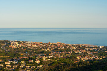 Naklejka na ściany i meble Panoramic view of the Maresme coast, north coast of the city of Barcelona. During sunset one day in late summer. We can see the Mediterranean sea completely flat.