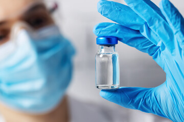 scientist medical worker with blank vaccine vial in hand. new product invention concept