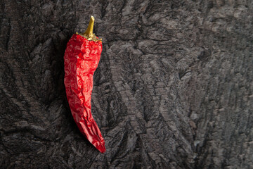 Red dried peppers. Hot dry peppers on a black charcoal surface.