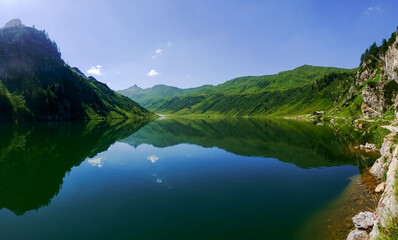 deep blue mountain lake with gorgeous reflection from the landscape panorama