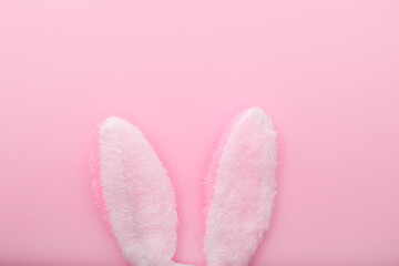 White rabbit ears on pink background, Easter minimal flat lay, top view, space for text