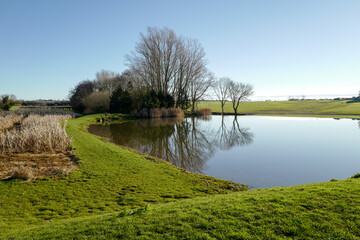 River Tove in Northamptonshire, England, UK on a beautiful sunny day with blue sky in January.