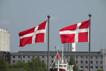 The flag of Denmark is also called Dannebrog, which means "Danish Cloth". The flag is red with a white cross that extends to the edges of the flag.