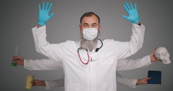 Senior multi-armed man doctor isolated on gray studio background