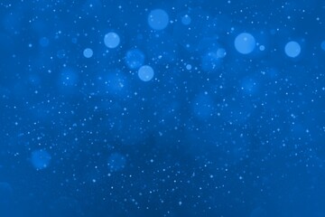 blue fantastic glossy glitter lights defocused bokeh abstract background with sparks fly, festal mockup texture with blank space for your content