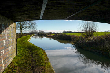 under a bridge on the Grand Union canal on a beautiful day in the countryside of Northampton, UK