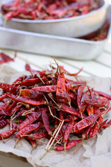 pile of dried red peppers on table outdoor