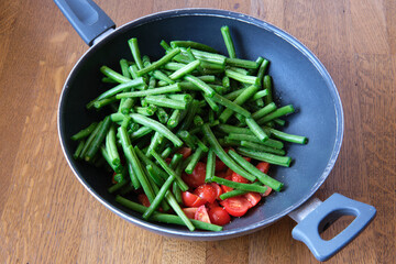 Italian recipe: farm fresh green beans with little tomatoes in a wok