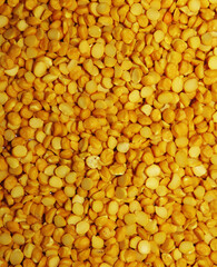 Split peas,Close up of Isolated Split peas,Split peas are an agricultural or culinary preparation consisting of the dried, peeled and split seeds of Pisum sativum, the pea.Background Texture.