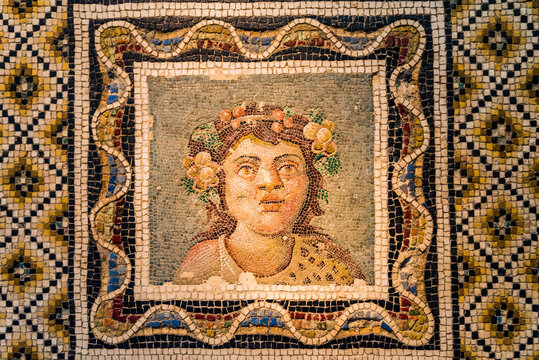 JUNE 14, 2019: Ancient Roman floor mosaic with bust of Dionysus at the Palazzo Massimo alle Terme of the Museo Nazionale Romano (National Roman Museum) in Rome, Italy.
