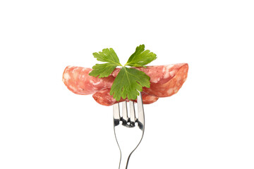 Three thin slices of cooked smoked sausage with parsley leaf.