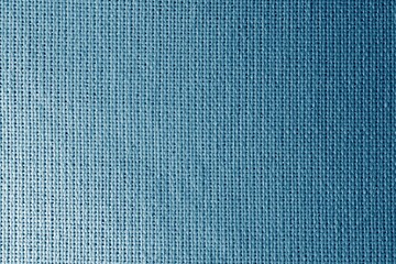 Shiny blue fabric texture. Blue fabric background with light and dark areas