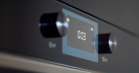 Close up of modern built-in oven with coking timer on display