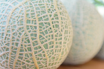 Closeup to split the juicy sweet green melon on wood plate