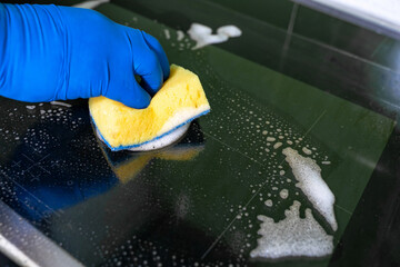 washing the electric stove with a sponge