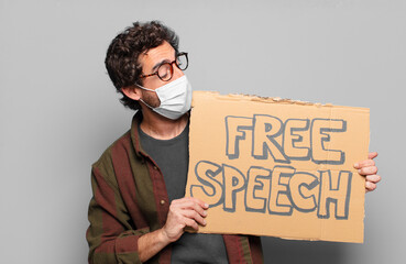 young bearded man with a medical mask and free speech concept