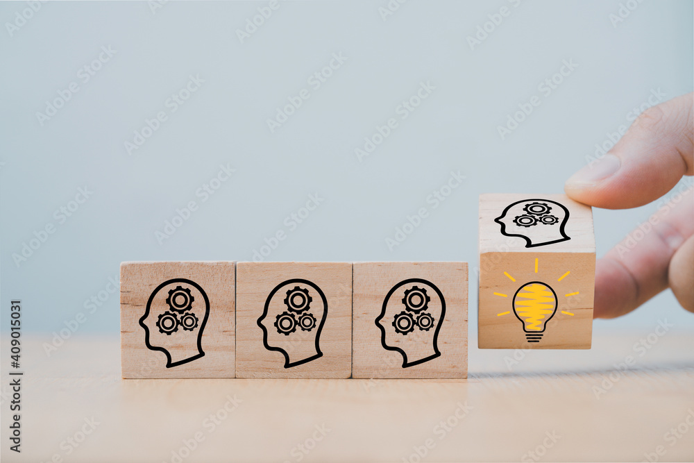 Poster hand flipping wooden cube block which print screen face with questions mark to lightbulb, creative i