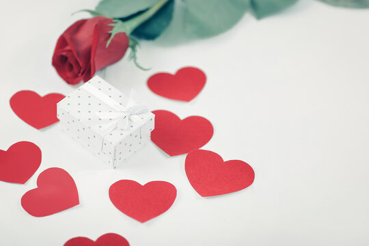 Valentine's day gift box on red rose background . photo with copy space