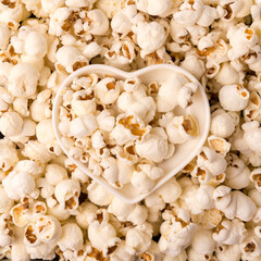 Some homemade Popcorn as detailed close-up shot, heart shaped bowl, top view