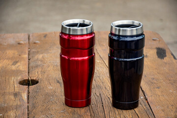 Insulated reusable stainless steel coffee travel tumbler mugs on the table