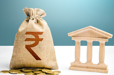 Indian rupee money bag and bank / government building. Budgeting, national financial system....