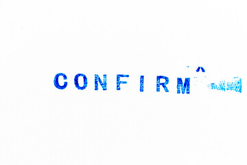 Blue color ink of rubber stamp in word confirm on white paper background