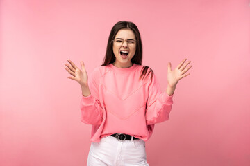 Photo of attractive young woman in glasses screaming yelling angry wear casual pink t-shirt white pants isolated pink color background