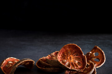 Dried quince on a black marble table