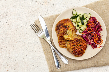 Healthy Paleo food with grilled meat, fresh cucumber, fermented cabbage and carrot