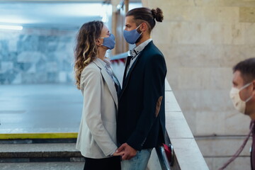 couple in love standing in a subway tunnel.