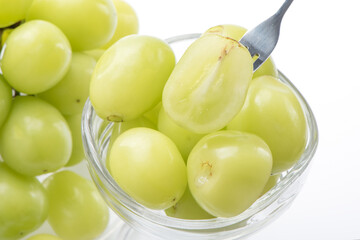 Beautiful Shine Muscat green grape in a glass cup isolated on white background.