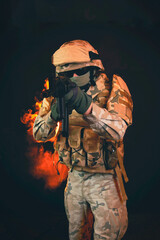 a soldier on fire holding a gun. Fight against terrorism - obrazy, fototapety, plakaty