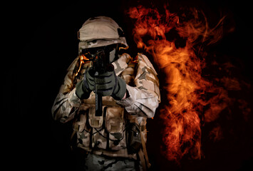 a soldier on fire holding a gun. Fight against terrorism - obrazy, fototapety, plakaty