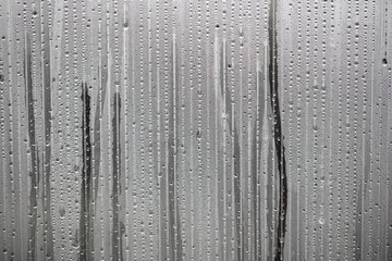 Water drops on glass as an abstract background.