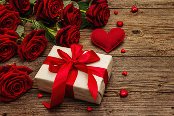 Fototapeta premium Valentine greeting card background with gift boxes, fresh burgundy roses and assorted hearts