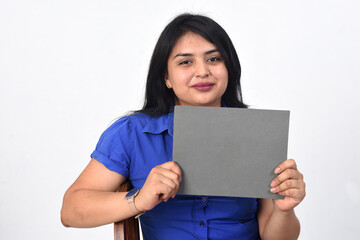 latin woman holding a blank on white background
