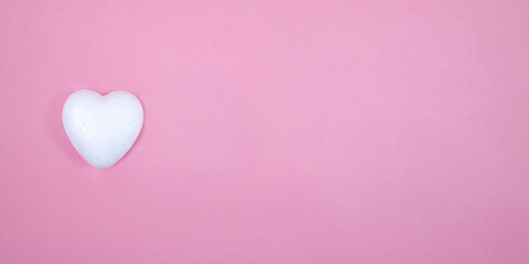 One little white heart on a pink background