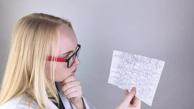 A neurologist examines an encephalogram of a patient&rsquo;s brain. Schedule of electroencephalograms study of brain currents for signs of epilepsy and pathologies of the nervous system