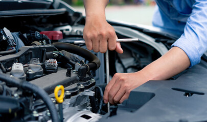 Plakat The male mechanic's hand holds the wrench In order to fix And check car engine, engineer concept and car repair