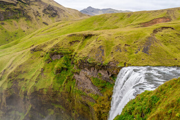 Sk&oacute;gafoss waterfall is in the middle of wonderful green icelandic landscape. It was shaped by Sk&oacute;g&aacute; river