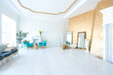 Luxury light interior of living room with gold wall and chic expensive furniture in white and gold...