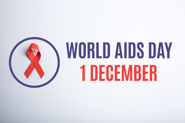 World AIDS day. 1-st December. Red handmade awareness paper ribbon on white background.