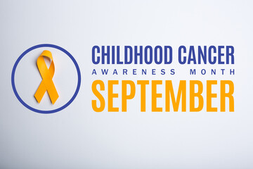 Childhood cancer awareness month. September. Yellow handmade awareness paper ribbon on white background.