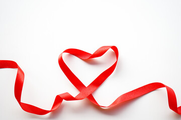 Red ribbon with heart shape on white background. Valentines day Or Love background concept. 